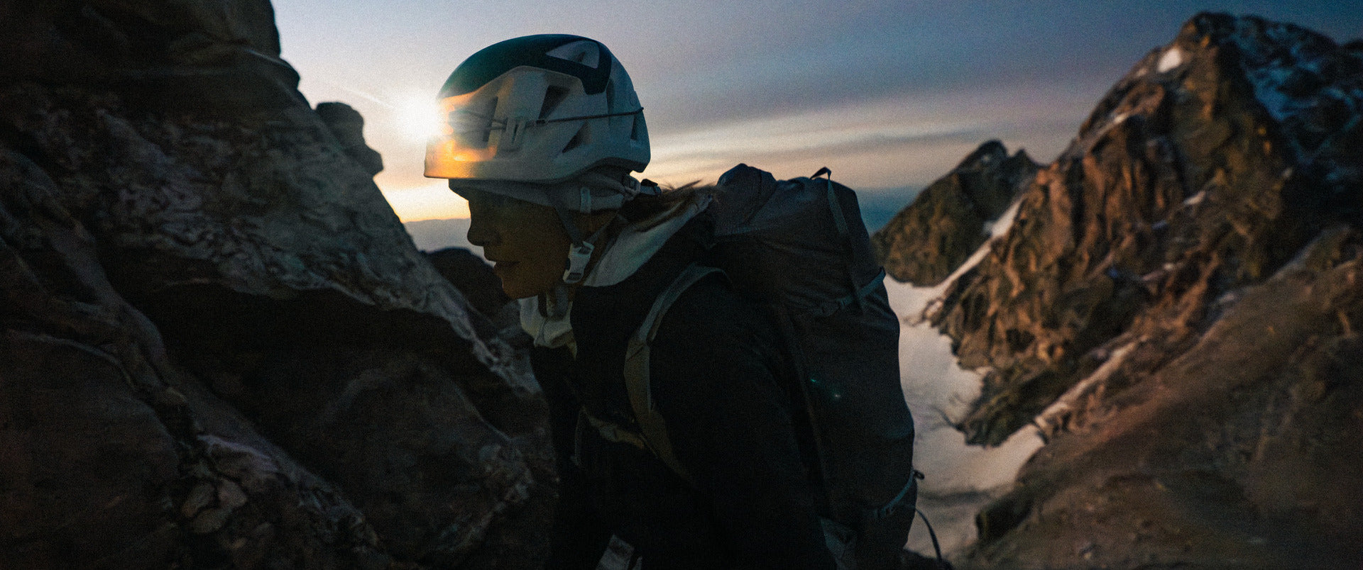 Landscape Woman wearing climbing equipment at dawn with mountain scenery